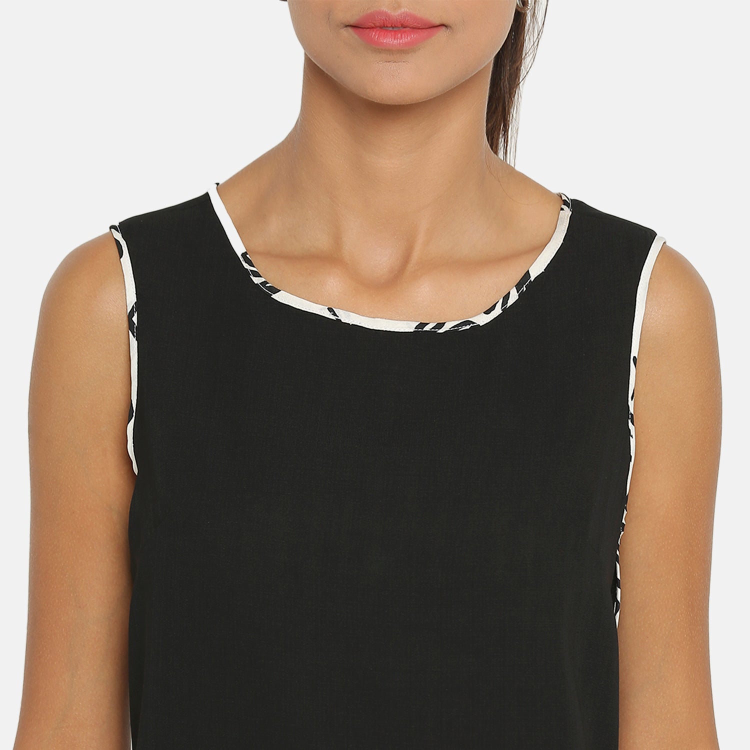 Black sleeveless top with contrast piping