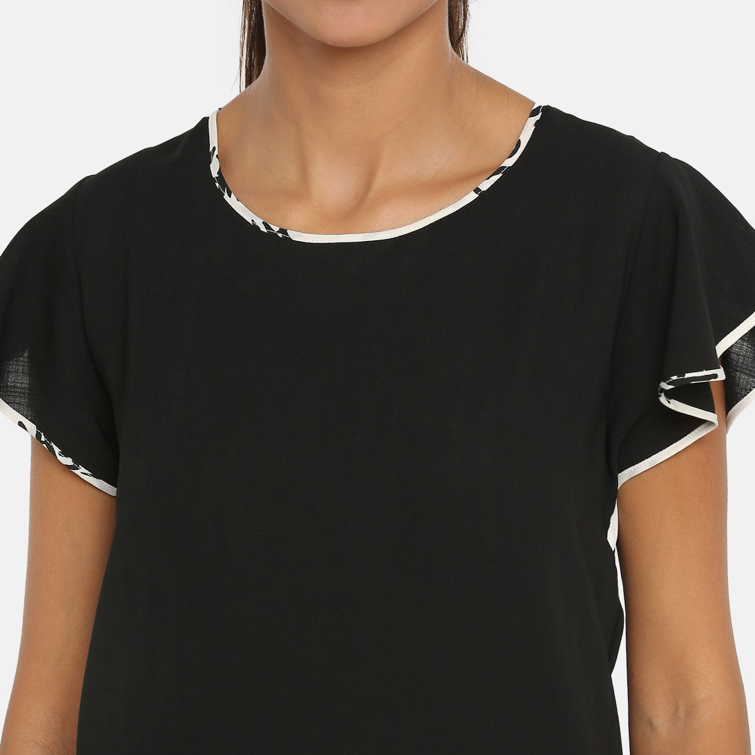Black top with frill on side seam with contrast pining